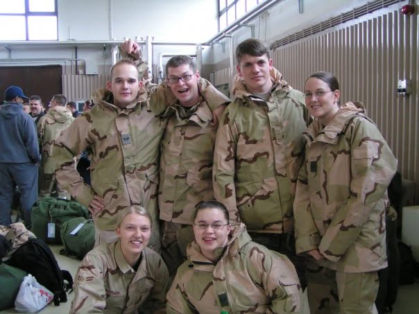 Hendrick posing with fellow service members in uniform