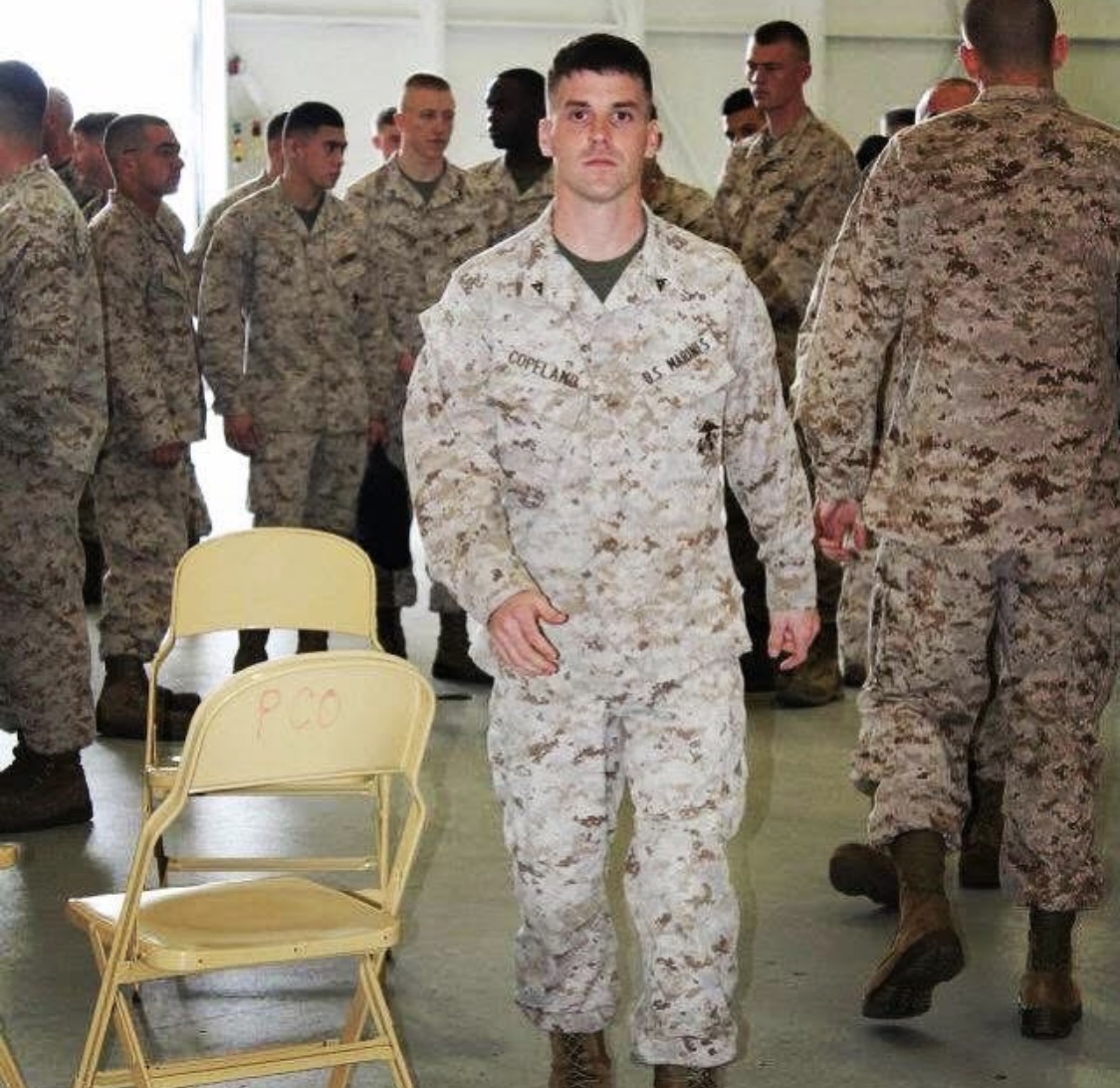 SSG Copeland in uniform walking toward photographer