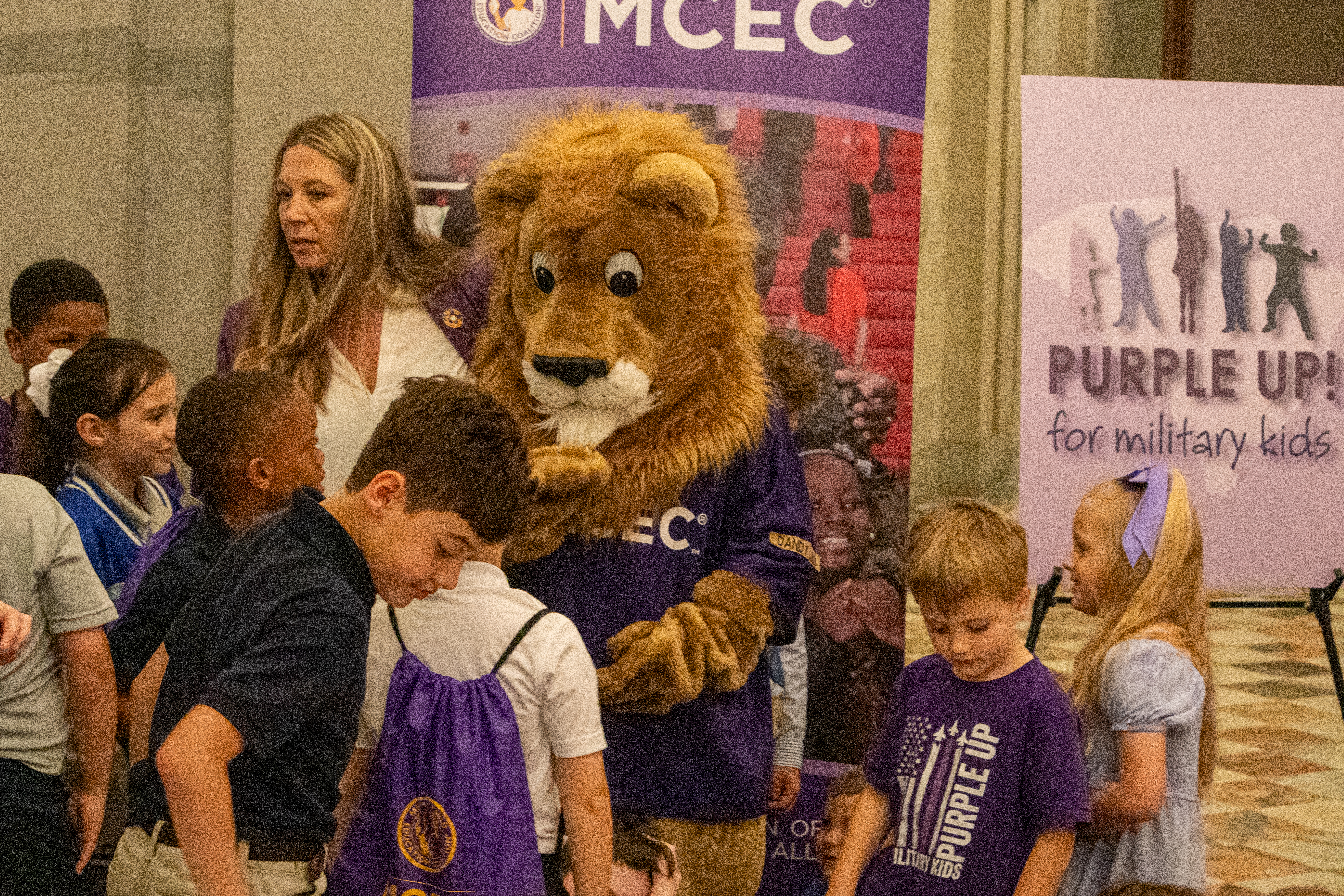 Dandi the lion with children at month of the military child proclamation reading