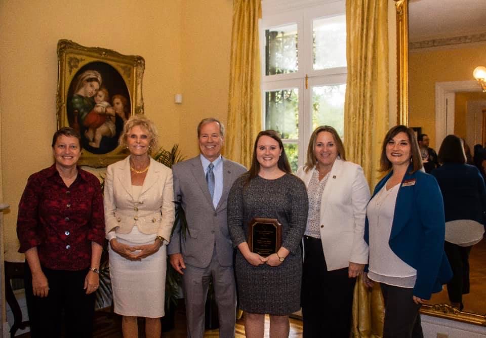 Keala Burks with group receiving an award