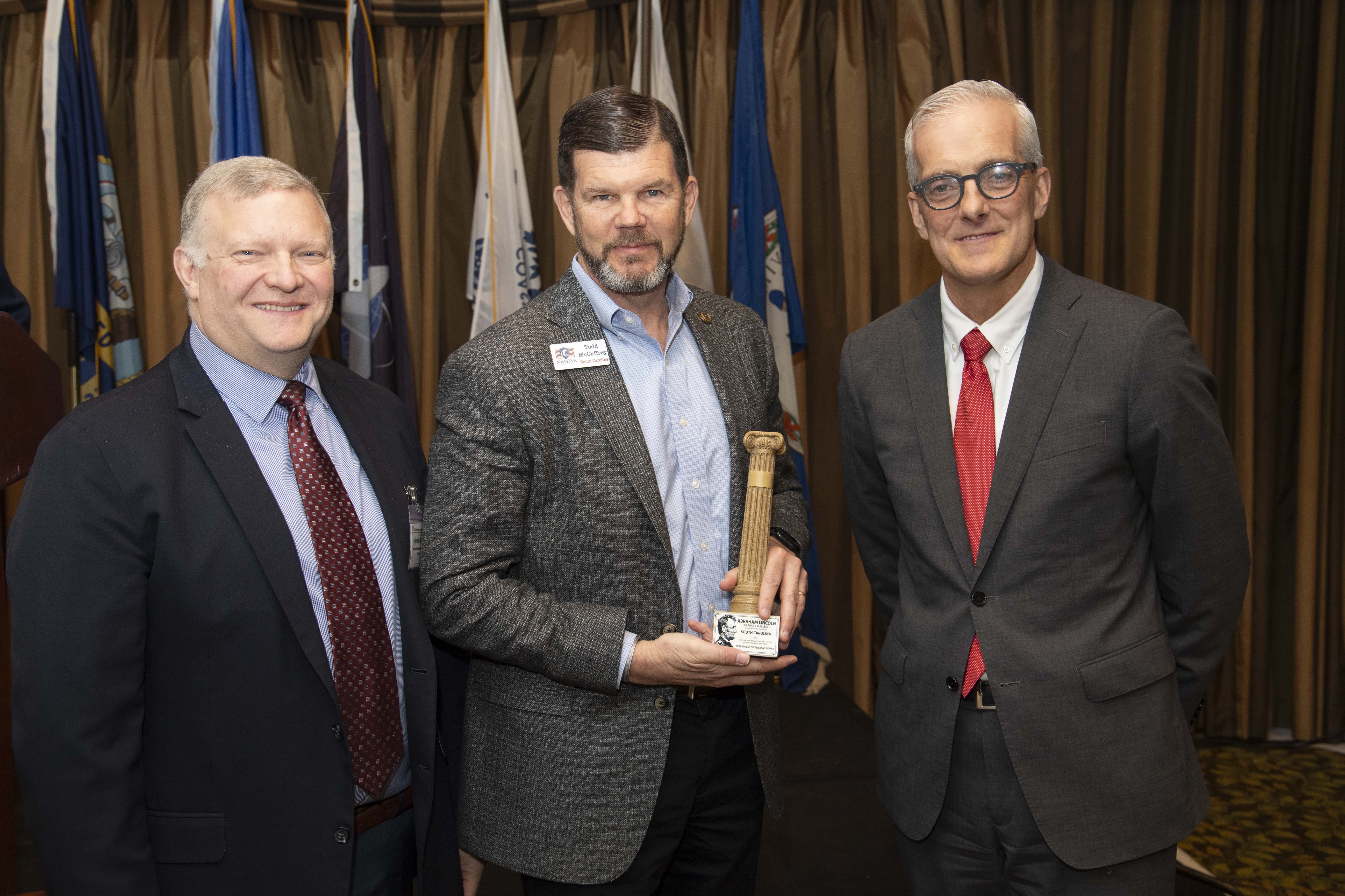 Secretary McCaffrey holds Pillars  of Excellence Award