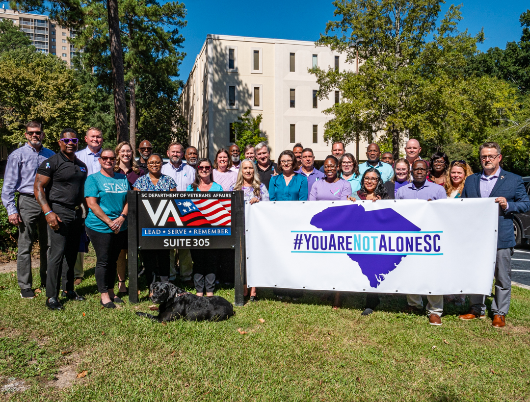 SCDVA Staff pose with the #YouAreNotAloneSC banner on Sept. 30, 2026.