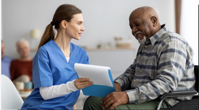 Nurse Talking to a Veteran in Wheelchair