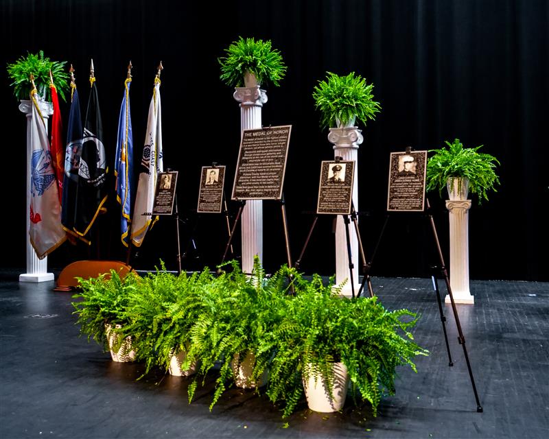Plaques displayed on stage at Liberty HS photo
