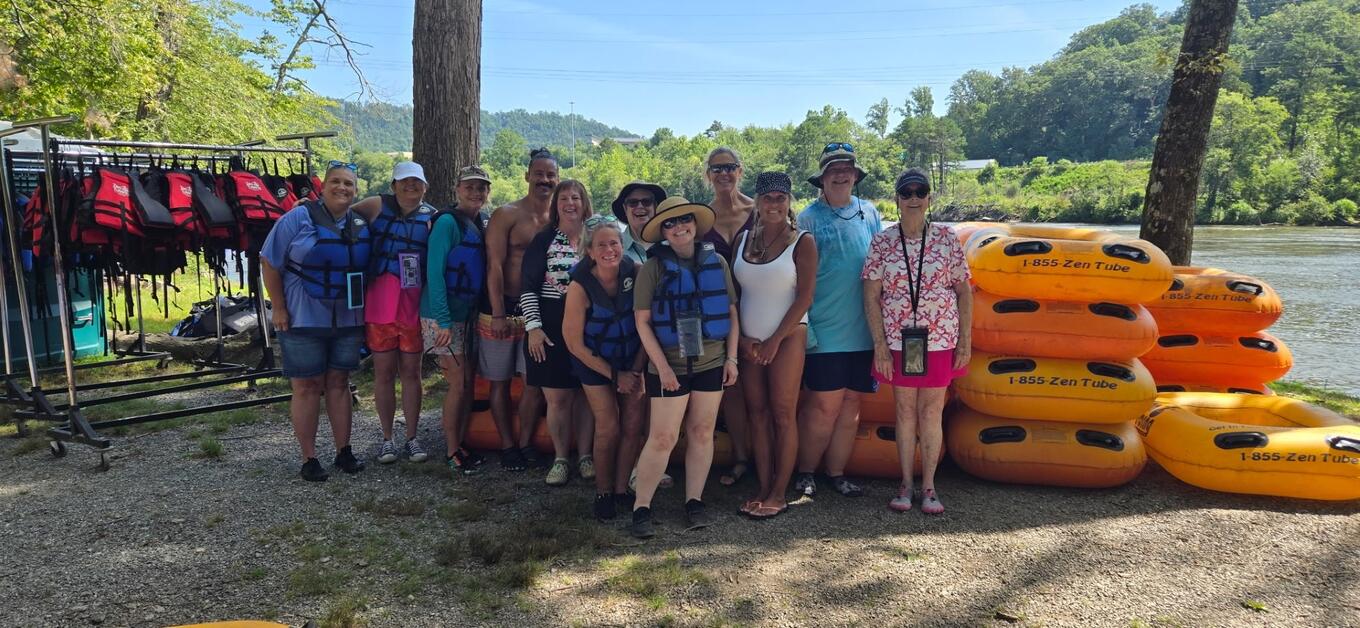 Participants of the Upstate Warrior Solution's Zen Tubing event along the French Broad River in North Carolina pose for a photo..